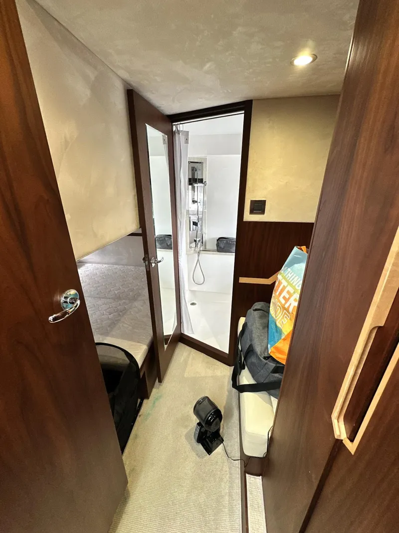 Slide: The Image of Interior of 2018 Galeon 385 HTS yacht, featuring cozy cabin and modern bathroom. - 14
