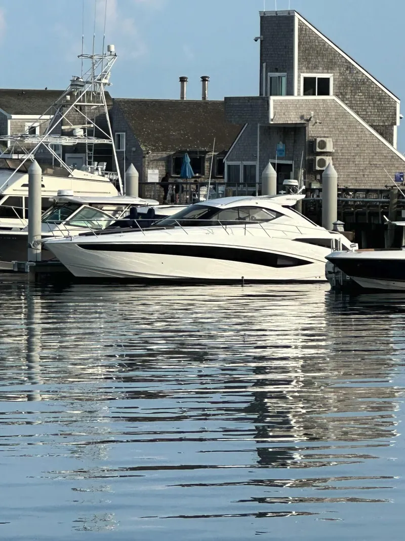 Slide: The Image of 2018 Galeon 385 HTS yacht docked at a marina with waterfront buildings. - 3