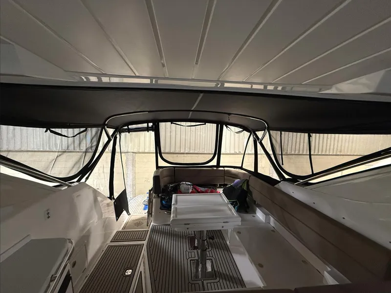 Slide: The Image of 2018 Galeon 385 HTS yacht interior with seating and table, under a canopy. - 8