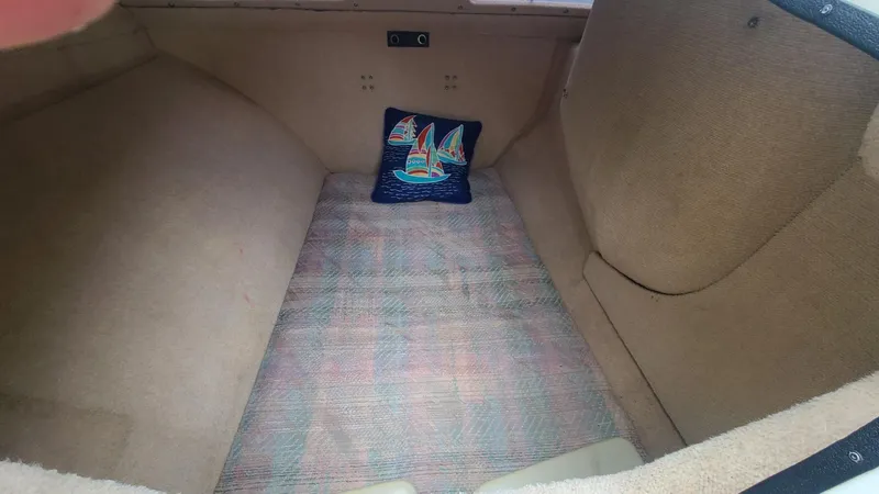 Slide: The Image of Interior cabin of 1992 Corsair F-27 sailboat with nautical-themed pillow. - 4