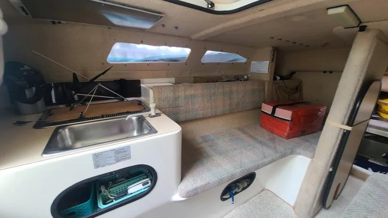 Slide: The Image of Interior of 1992 Corsair F-27 sailboat with kitchenette and seating area. - 6