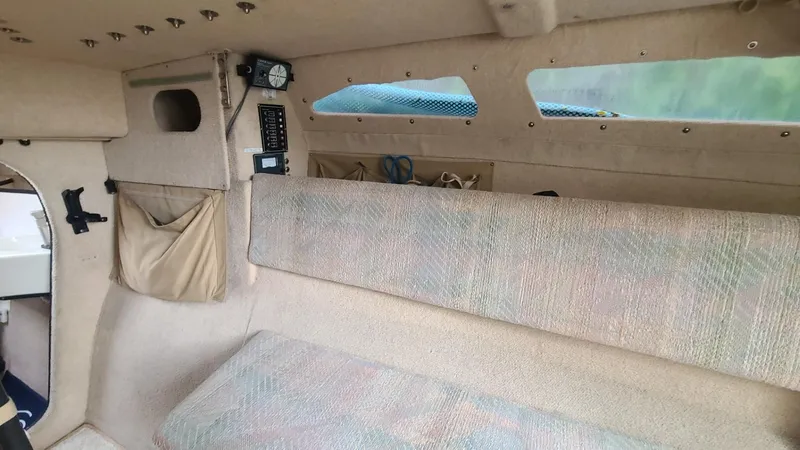 Slide: The Image of Interior of 1992 Corsair F-27 sailboat, featuring seating and storage compartments. - 8