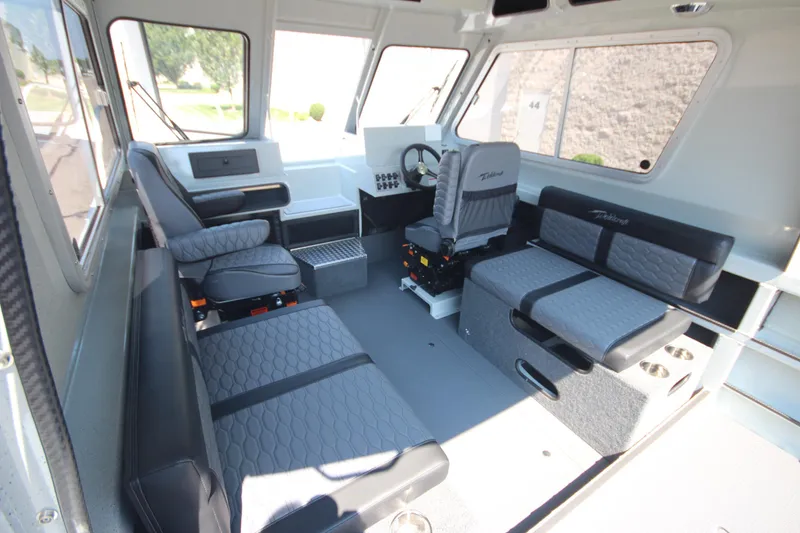 Slide: The Image of Interior of 2026 Weldcraft 220 Ocean King F250 boat, featuring modern seating and controls. - 16