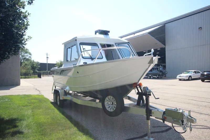 Slide: The Image of 2026 Weldcraft 220 Ocean King F250 boat on trailer, parked outside a warehouse. - 3