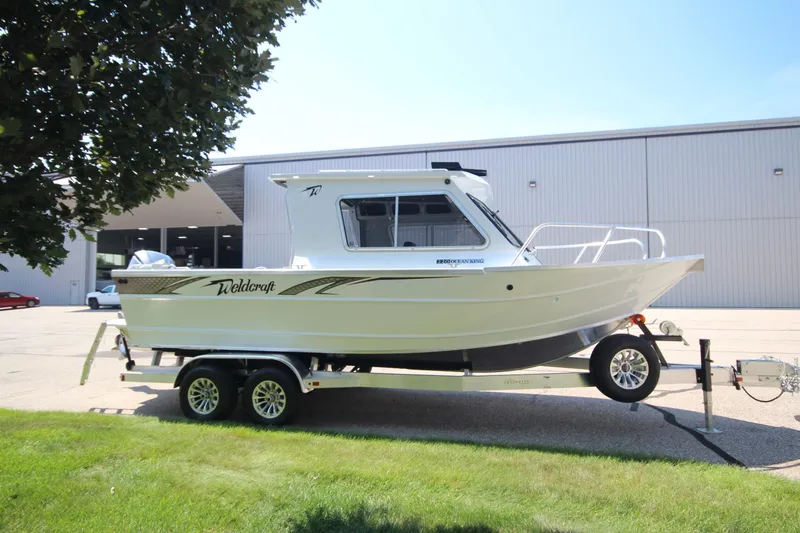 Slide: The Image of 2026 Weldcraft 220 Ocean King F250 boat on trailer, parked outdoors. - 4