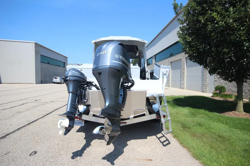 Slide: The Image of 2026 Weldcraft 220 Ocean King F250 boat with dual Yamaha engines, parked outdoors. - 6