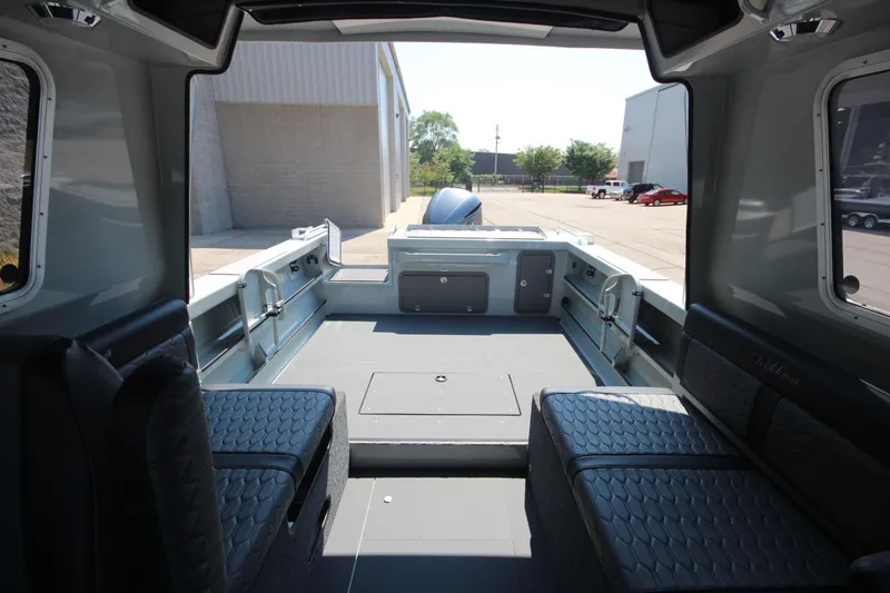 Slide: The Image of Interior view of 2026 Weldcraft 220 Ocean King F250 boat, showcasing seating and spacious deck. - 9