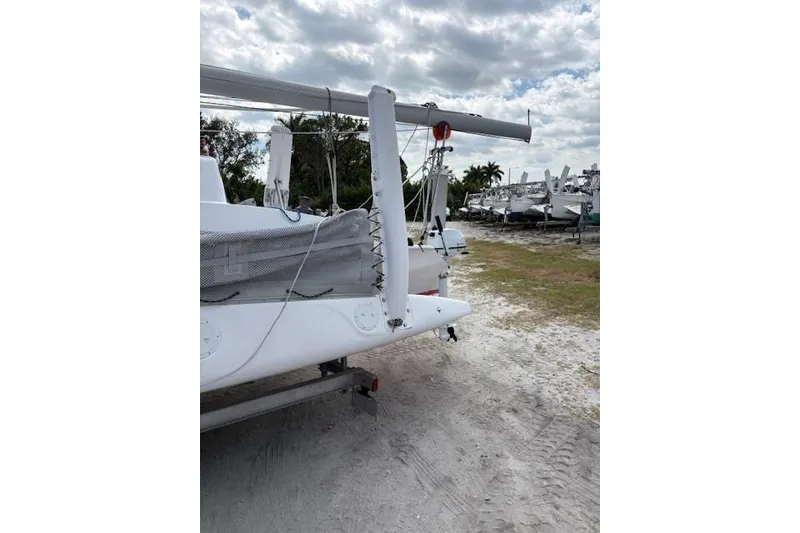 Slide: The Image of 2012 Corsair Dash 750 #413 sailboat on sandy ground under cloudy sky. - 17