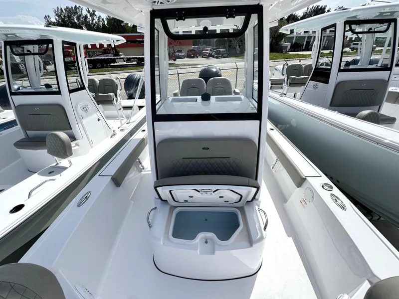 Slide: The Image of 2025 Sportsman Masters 247 Bay Boat interior with seating and storage compartments. - 11