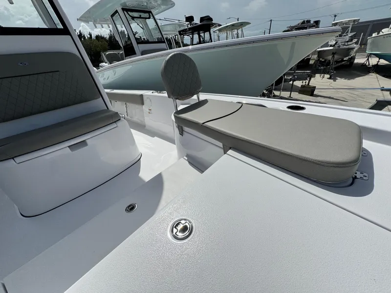 Slide: The Image of 2025 Sportsman Masters 247 Bay Boat interior with cushioned seating and sleek design. - 13