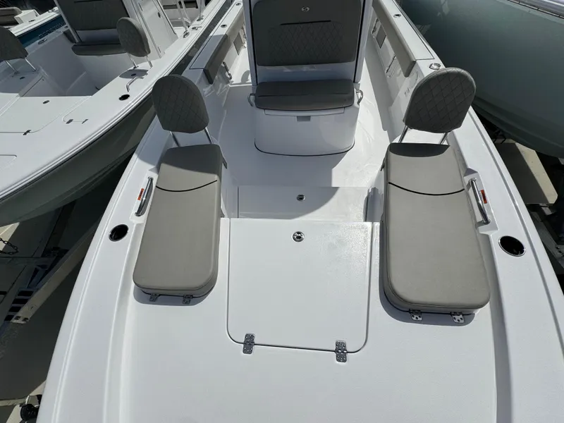 Slide: The Image of 2025 Sportsman Masters 247 Bay Boat interior with cushioned seating and storage compartments. - 14