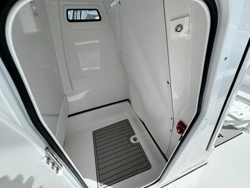 Slide: The Image of Interior view of 2025 Sportsman Masters 247 Bay Boat's cabin with window and flooring. - 15