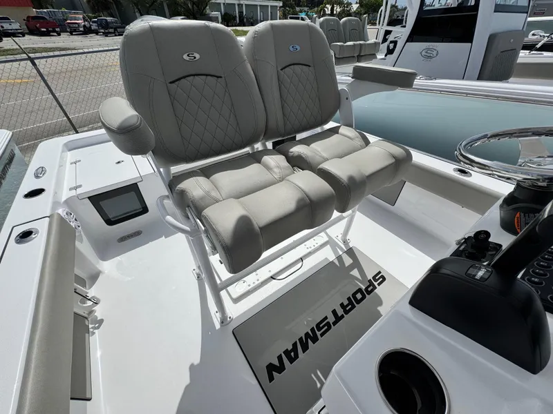 Slide: The Image of 2025 Sportsman Masters 247 Bay Boat with dual cushioned seats and modern console. - 18