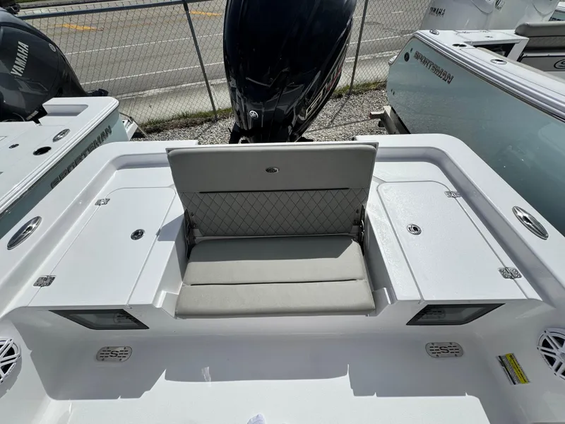 Slide: The Image of 2025 Sportsman Masters 247 Bay Boat with cushioned seating and storage compartments. - 26