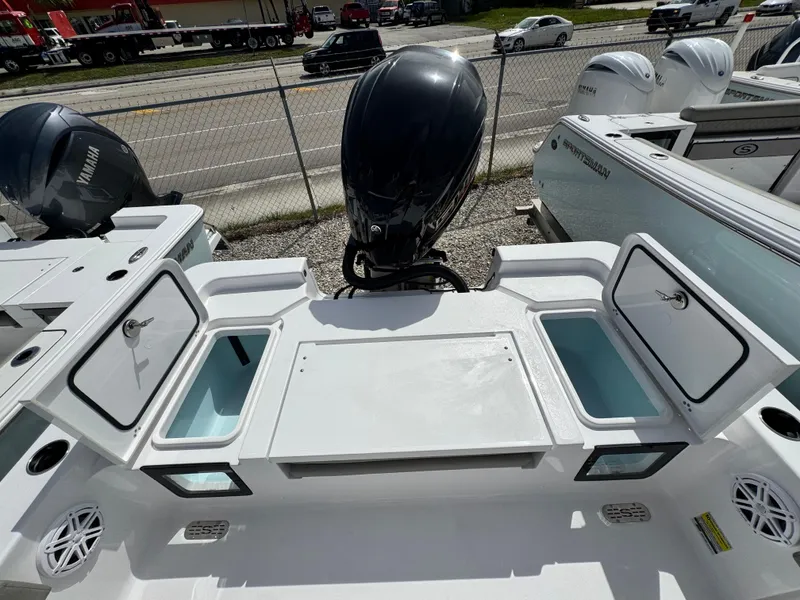 Slide: The Image of 2025 Sportsman Masters 247 Bay Boat with open storage compartments and Yamaha outboard motor. - 27