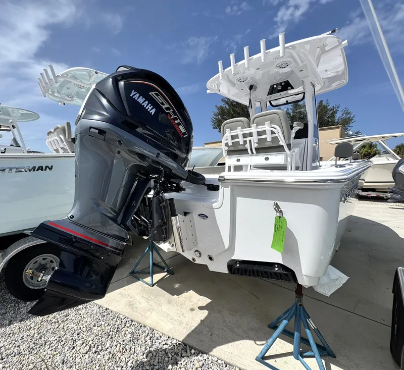 Slide: The Image of 2025 Sportsman Masters 247 Bay Boat with Yamaha engine, displayed outdoors on stands. - 5