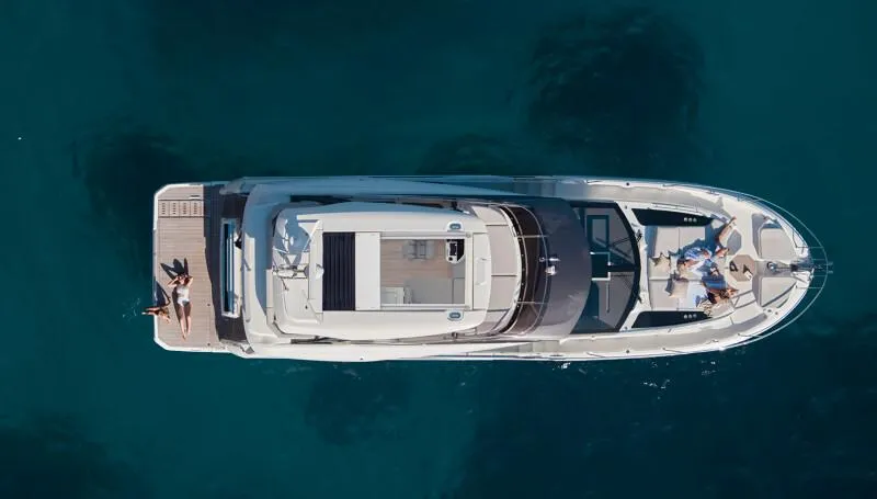 Slide: The Image of Aerial view of 2026 Prestige F5.7 yacht on clear blue water. - 10