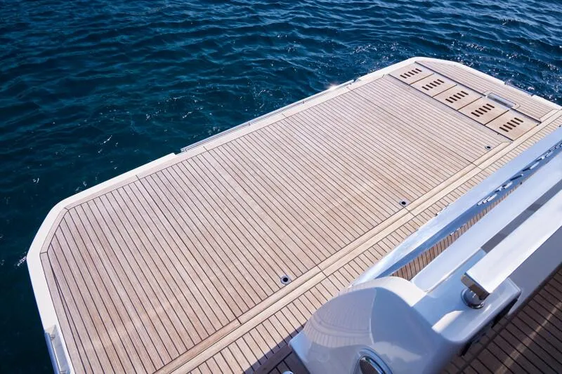 Slide: The Image of Luxury yacht deck of Prestige F5.7, 2026 model, overlooking serene blue ocean waters. - 13