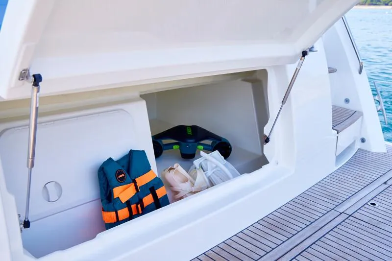 Slide: The Image of Storage compartment on 2026 Prestige F5.7 boat with life jacket and accessories. - 14