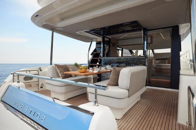 Slide: The Image of Luxury yacht Prestige F5.7, 2026 model, featuring elegant outdoor seating and dining area. - 16