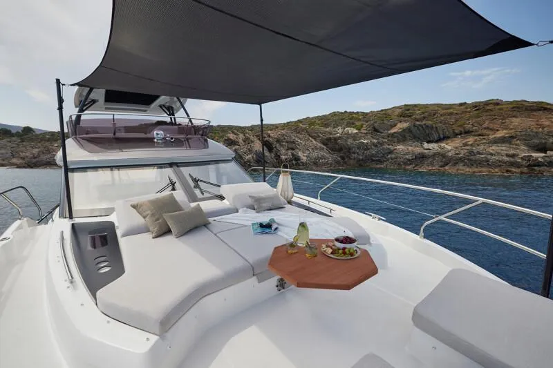 Slide: The Image of Luxurious 2026 Prestige F5.7 yacht with sunbathing deck and scenic coastal view. - 24