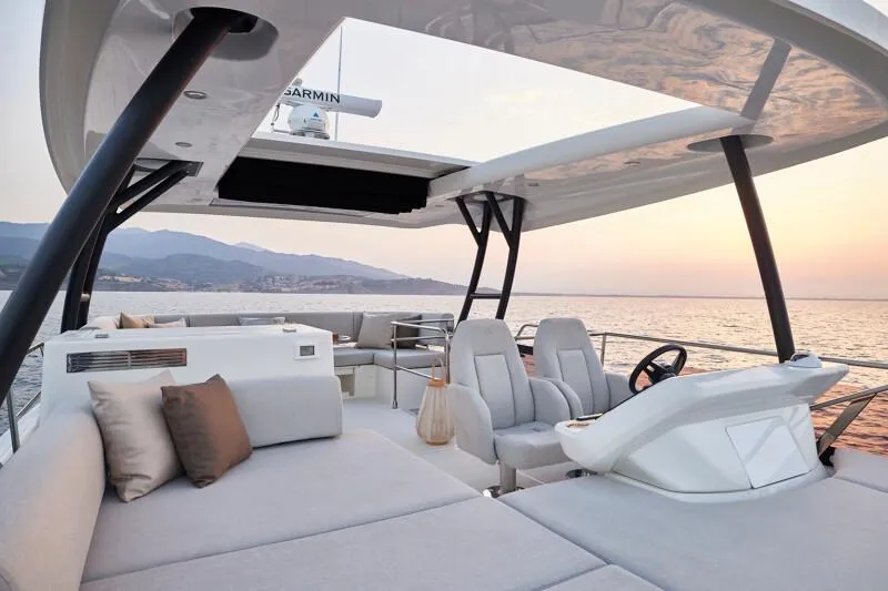 Slide: The Image of Luxurious 2026 Prestige F5.7 yacht interior with elegant seating, ocean view, and sunset backdrop. - 30