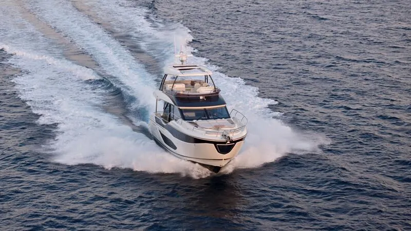 Slide: The Image of Luxury yacht Prestige F5.7 2026 cruising on open water, creating a dynamic wake. - 6