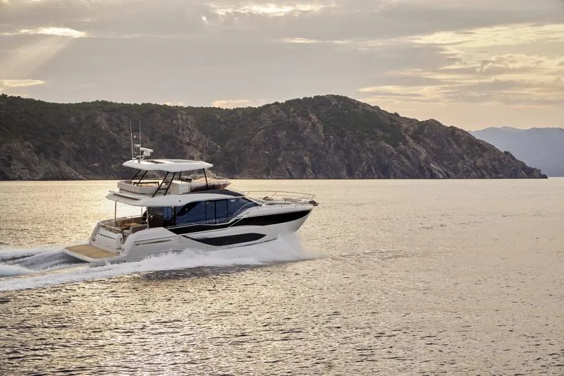 Slide: The Image of Luxury Prestige F5.7 yacht cruising near scenic coastline, 2026 model. - 7