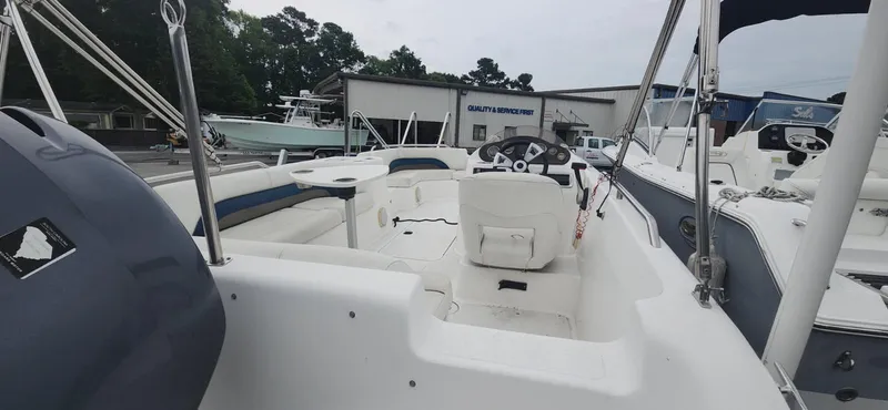 The Image of 2013 Hurricane SunDeck Sport 201 OB boat interior with steering wheel and seating. - 1