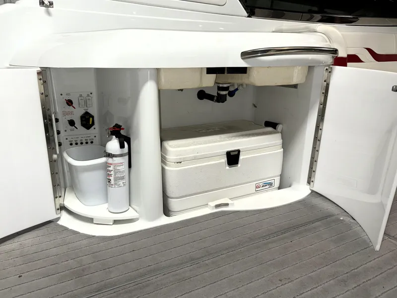 Slide: The Image of 2008 Formula 330 Sun Sport storage compartment with cooler and fire extinguisher. - 13