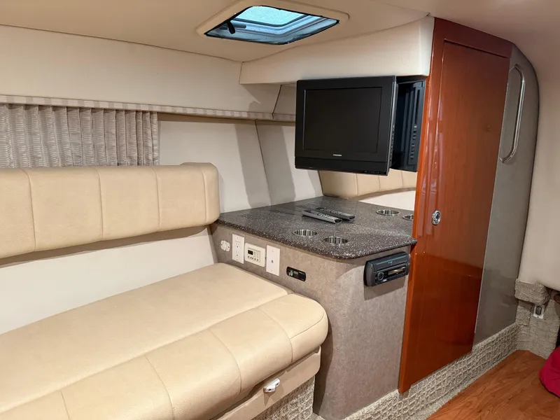 Slide: The Image of Interior of 2008 Formula 330 Sun Sport boat with seating, TV, and storage. - 22