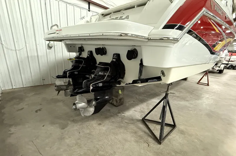 Slide: The Image of 2008 Formula 330 Sun Sport boat on stands, showcasing dual propellers in a garage. - 3
