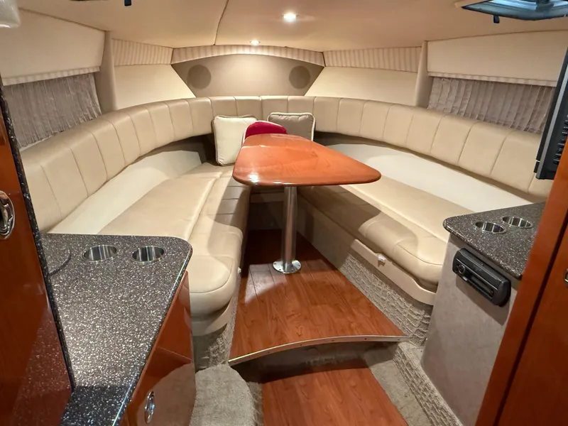 Slide: The Image of Luxurious interior of 2008 Formula 330 Sun Sport boat with plush seating and wooden table. - 30
