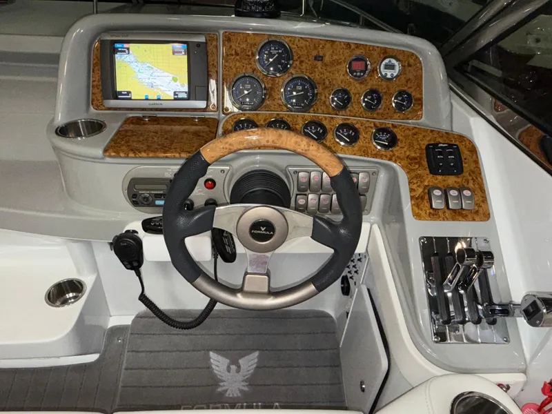 Slide: The Image of 2008 Formula 330 Sun Sport dashboard with GPS, gauges, and controls. - 33