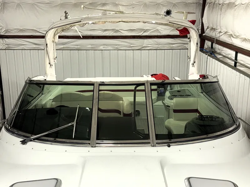 Slide: The Image of 2008 Formula 330 Sun Sport boat in storage, featuring a sleek windshield and spacious interior. - 8