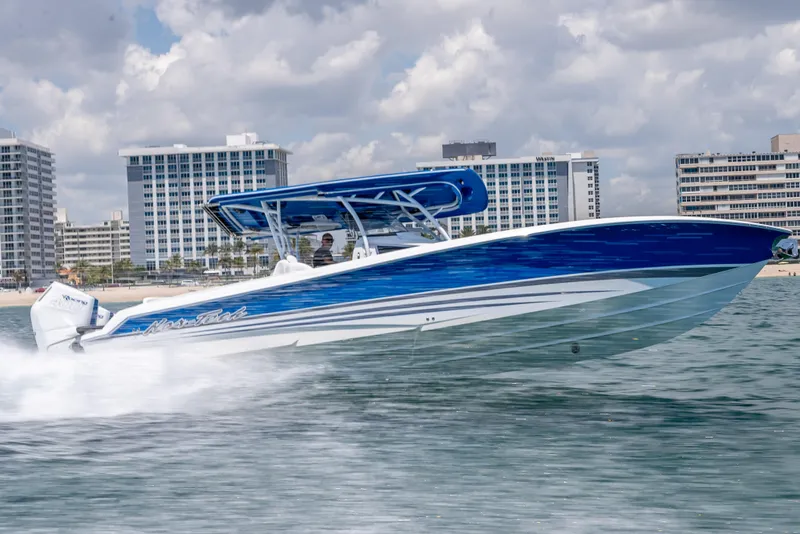 Slide: The Image of 2025 Nor-Tech 340 Sport boat cruising on water, with city skyline in background. - 10