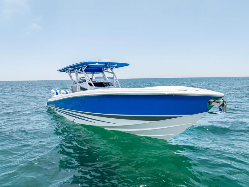 Slide: The Image of 2025 Nor-Tech 340 Sport boat in blue, cruising on open water under clear skies. - 14
