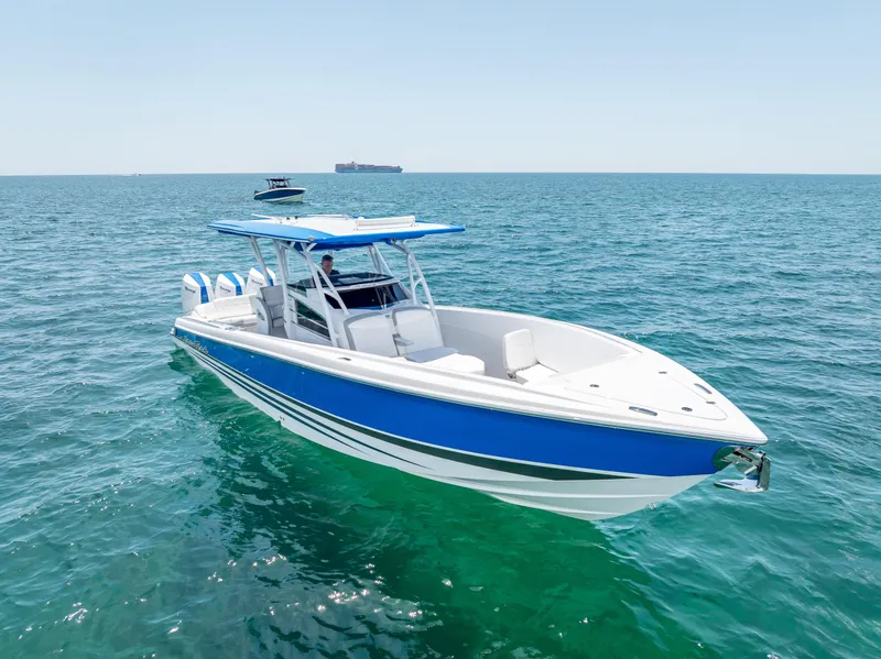 Slide: The Image of 2025 Nor-Tech 340 Sport boat on open sea, featuring sleek blue and white design. - 15