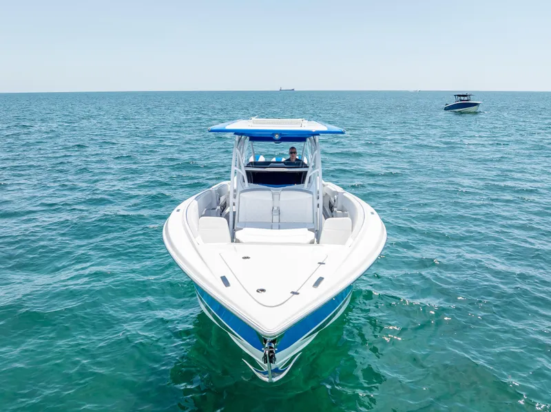Slide: The Image of 2025 Nor-Tech 340 Sport boat on open water, showcasing sleek design and vibrant blue accents. - 16