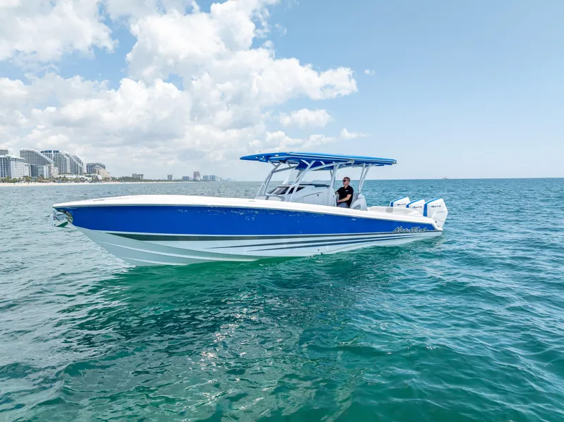 Slide: The Image of 2025 Nor-Tech 340 Sport boat on open water, blue and white design, clear sky background. - 18