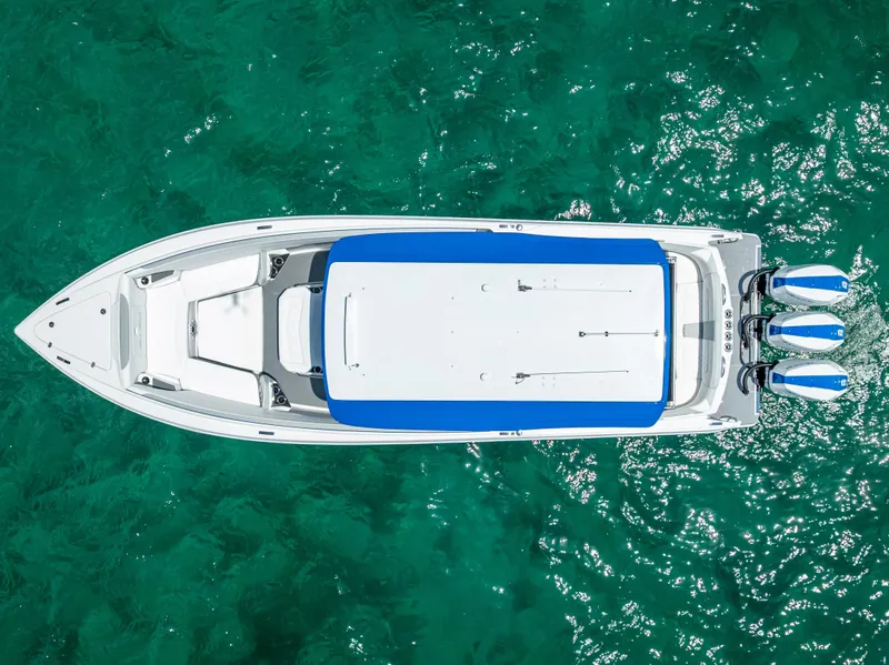 Slide: The Image of 2025 Nor-Tech 340 Sport boat on turquoise water, aerial view. - 19