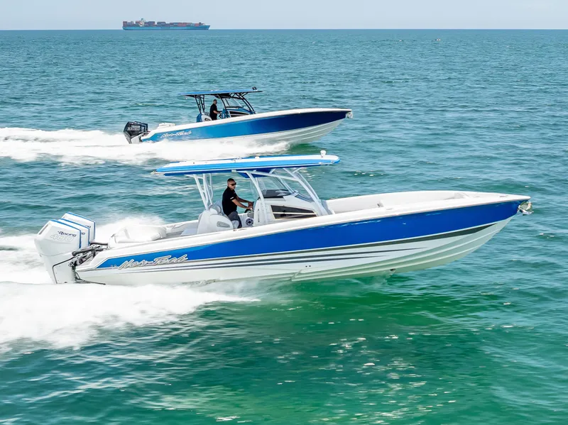 Slide: The Image of 2025 Nor-Tech 340 Sport boats cruising on open water, showcasing sleek design and performance. - 21