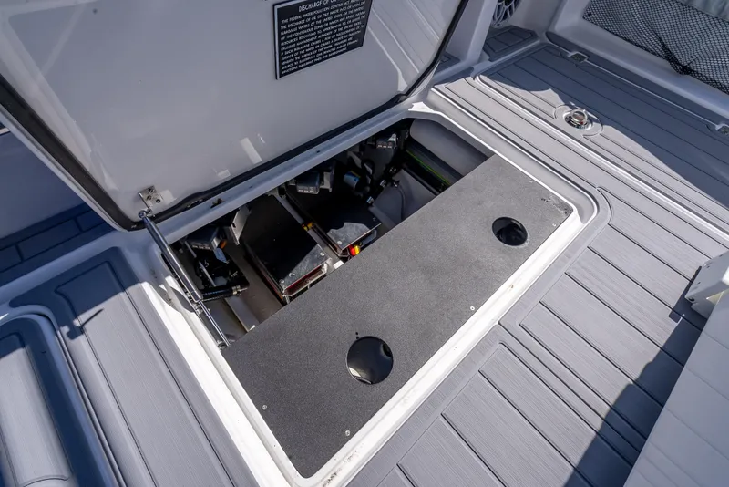 Slide: The Image of 2025 Nor-Tech 340 Sport boat storage compartment with open hatch, showcasing interior details. - 27