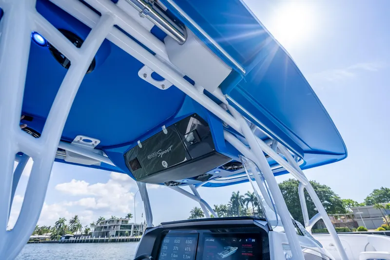 Slide: The Image of 2025 Nor-Tech 340 Sport boat with blue canopy and advanced navigation system. - 32