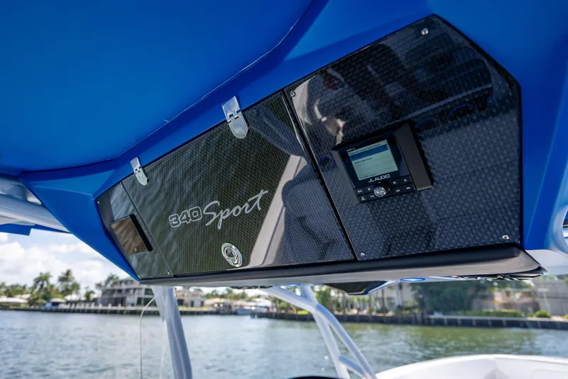 Slide: The Image of 2025 Nor-Tech 340 Sport boat dashboard with carbon fiber finish and digital display. - 33
