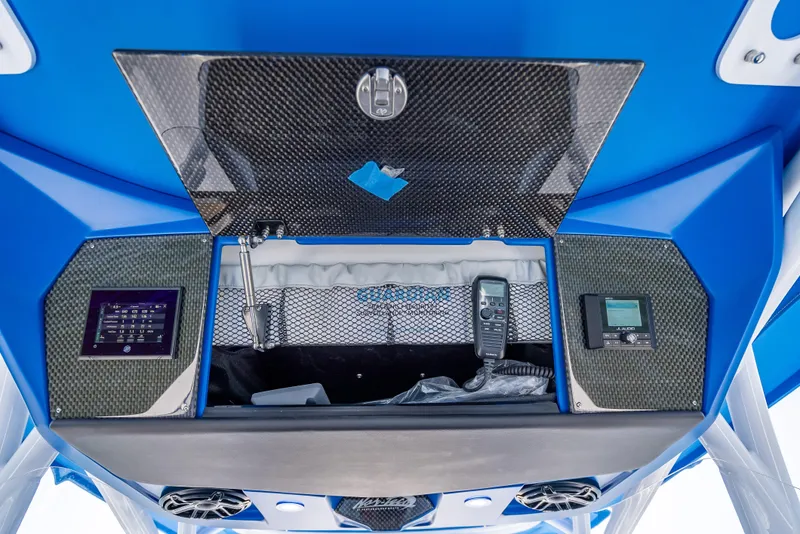 Slide: The Image of 2025 Nor-Tech 340 Sport boat dashboard with advanced controls and storage compartment. - 34