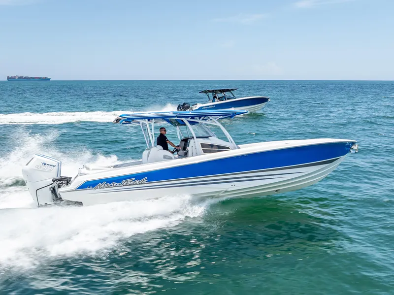 Slide: The Image of 2025 Nor-Tech 340 Sport boat cruising on open water, showcasing sleek design and performance. - 4