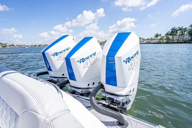 Slide: The Image of 2025 Nor-Tech 340 Sport boat with triple Racing 400 outboard engines on a sunny day. - 41