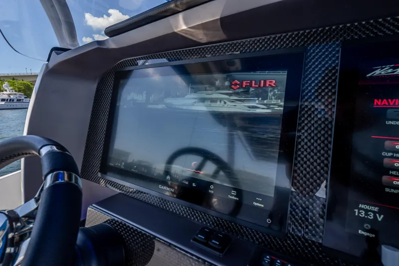 Slide: The Image of 2025 Nor-Tech 340 Sport dashboard with FLIR display and navigation controls. - 44
