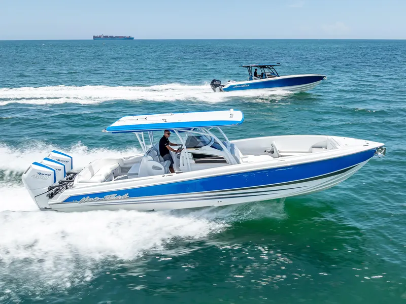 Slide: The Image of 2025 Nor-Tech 340 Sport boats cruising on open water, showcasing sleek design and performance. - 48